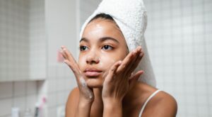 A lady applying skincare to her face