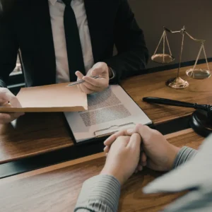 A US trademark lawyer sitting with their client at a desk