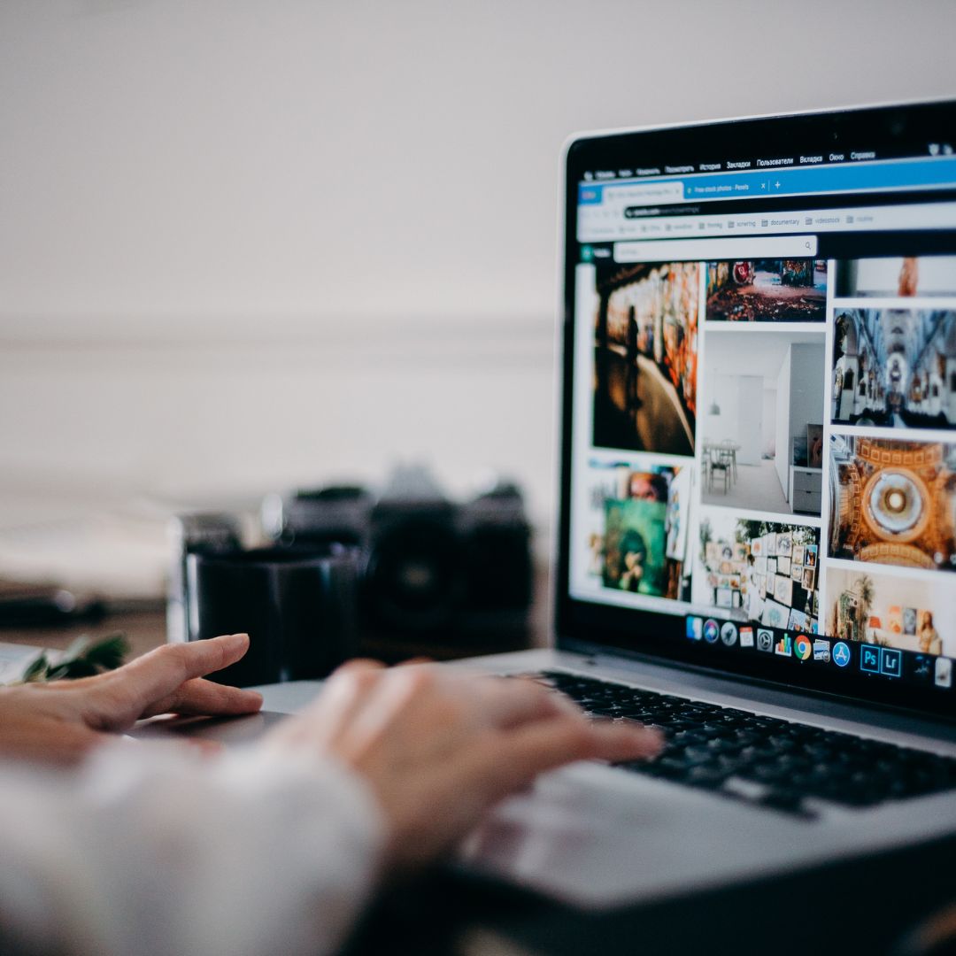 Someone searching for stock images on a laptop