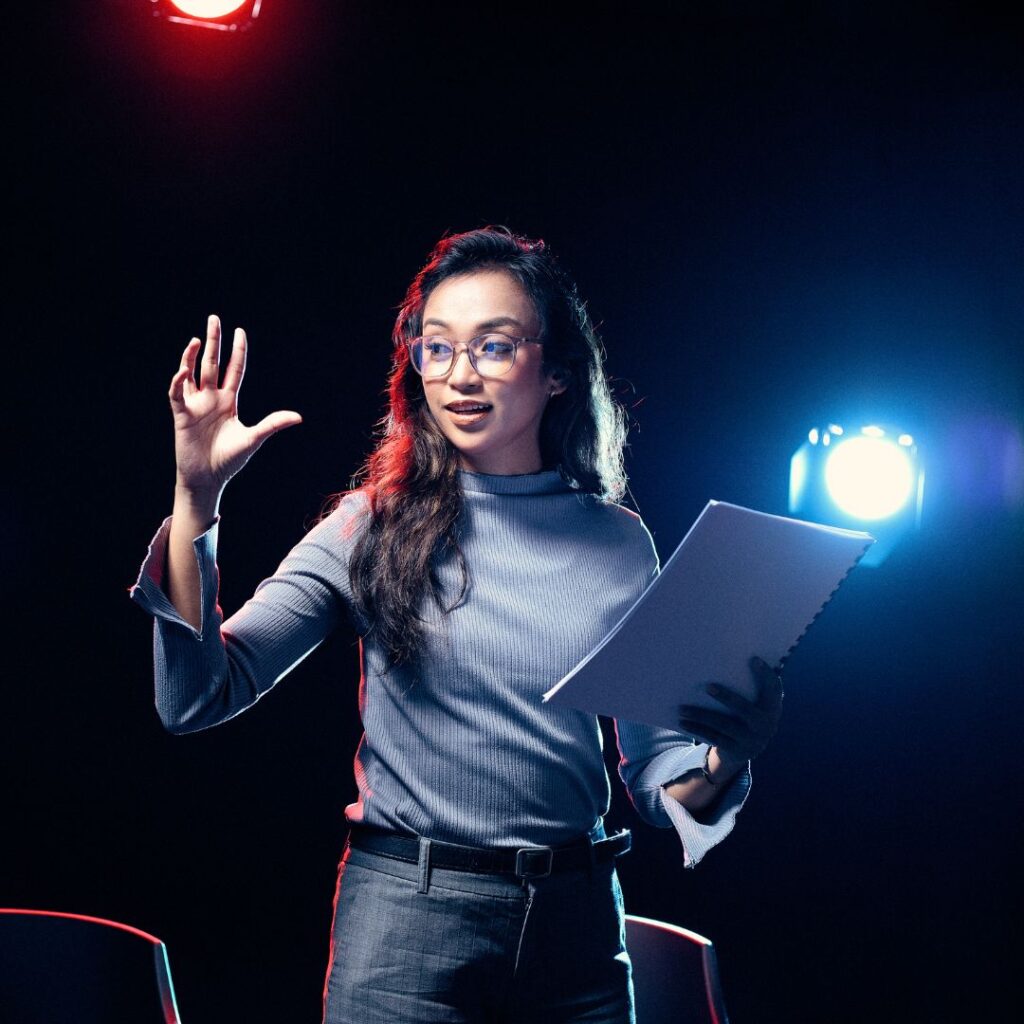 A public figure presenting on stage