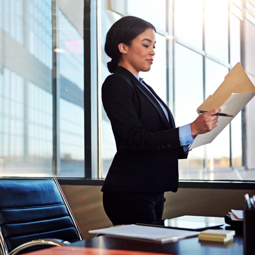 A female IP lawyer reviewing a case file in her office