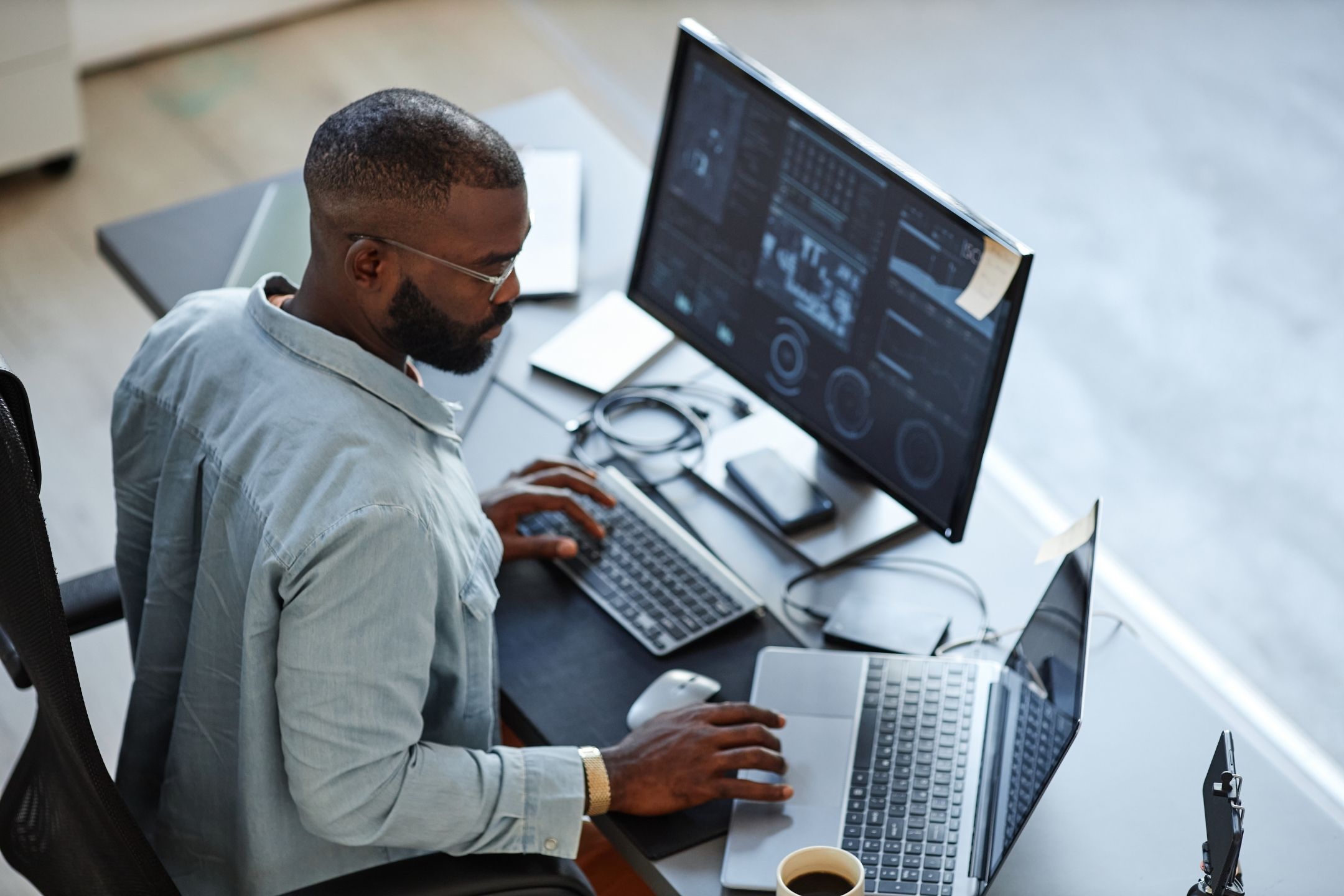 An entrepreneur sat at his desk, reviewing software on the computer screen.