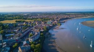 Aerial shot of Colchester, with houses and buildings down by the water side
