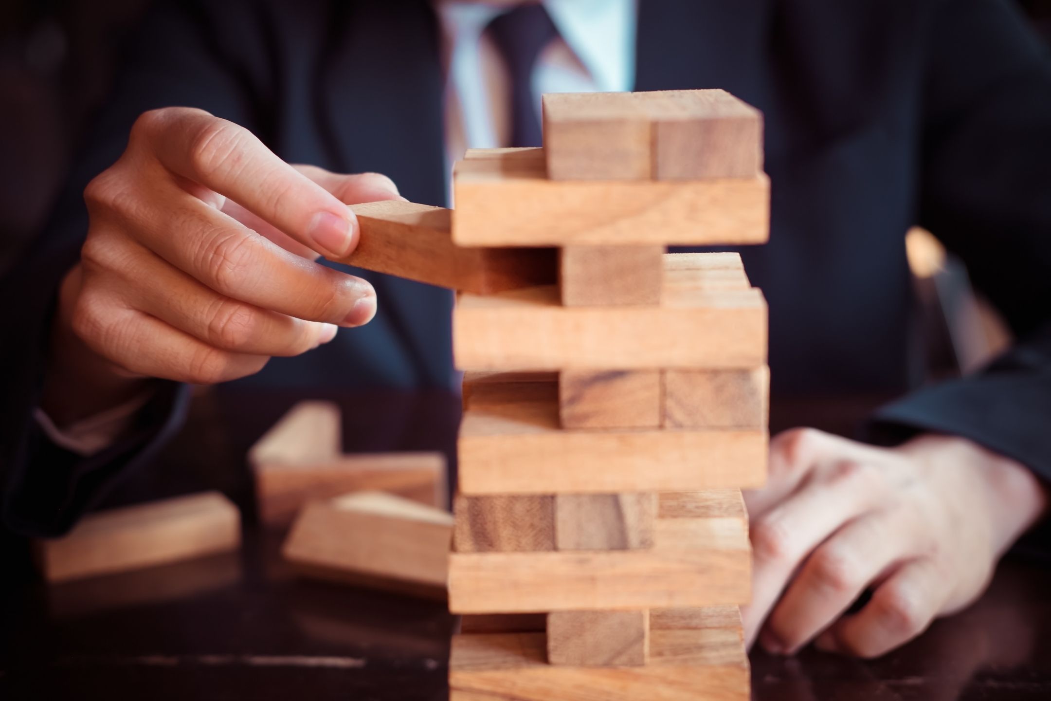 IP law pulling out blocks from a jenga-style tower