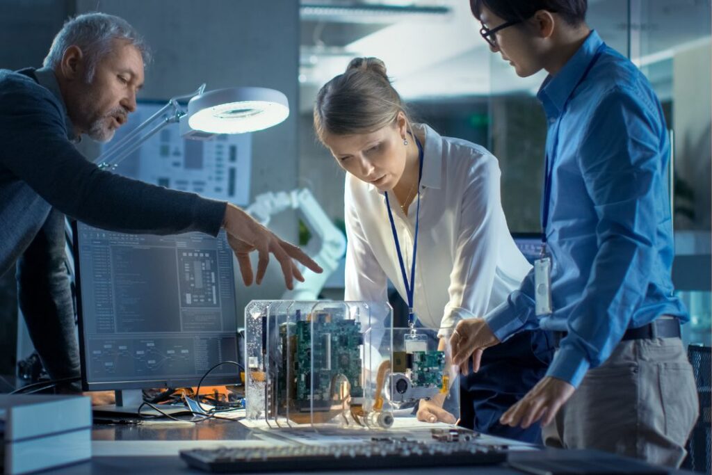 Three inventors, reviewing their innovation before applying for a patent