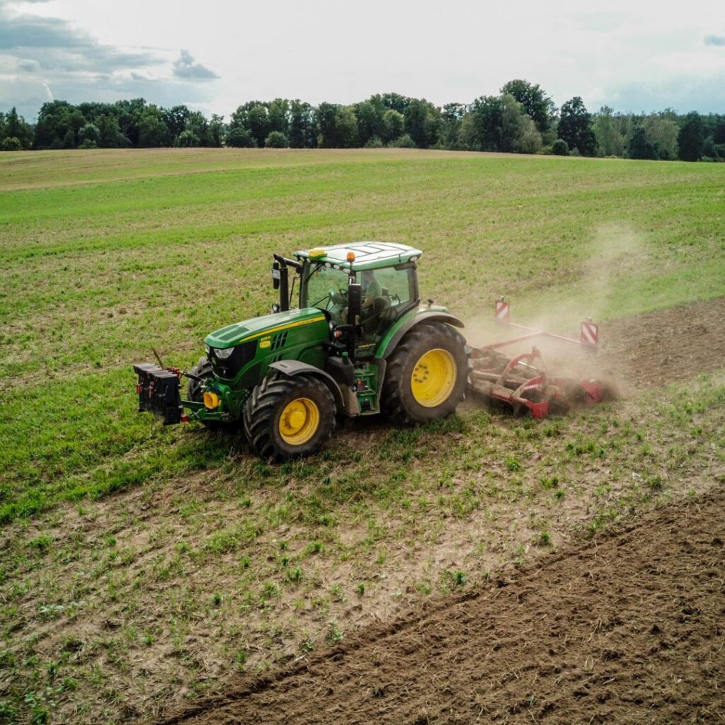 A tractor ploughing through a field.