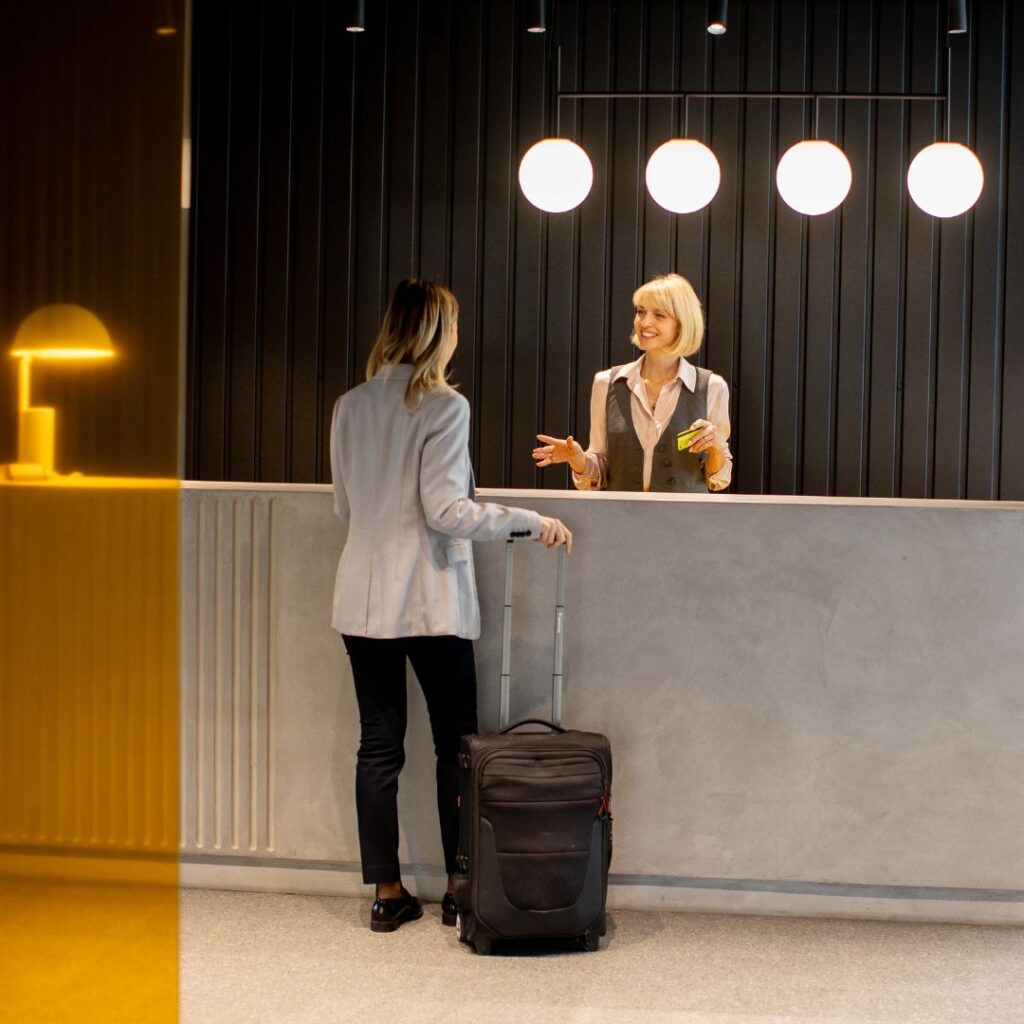 A female traveller checking into a hotel reception
