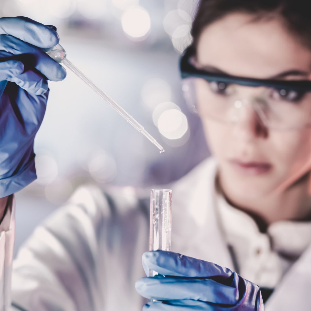 A female life scientist holding a pipette.