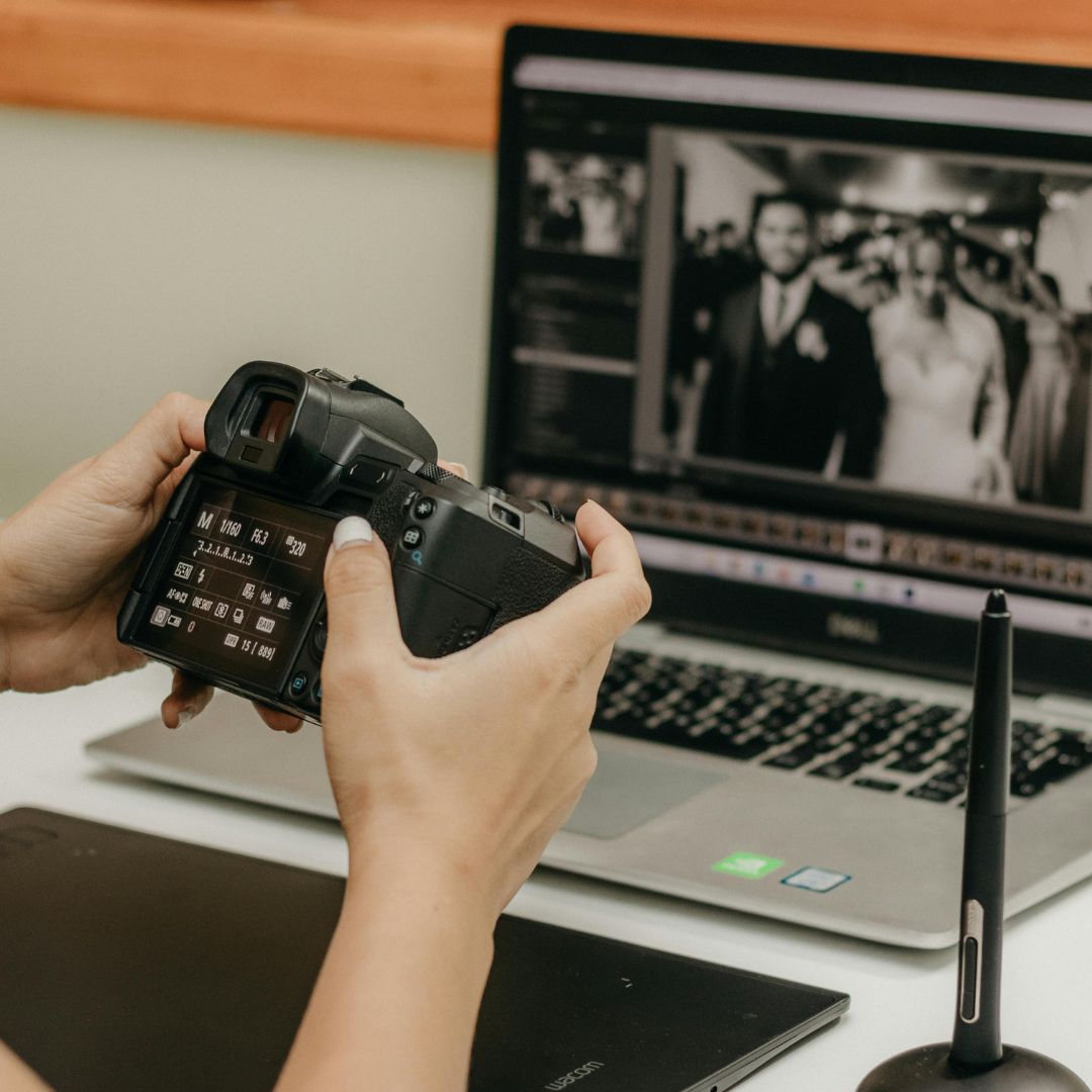 A photographer reviewing wedding shots