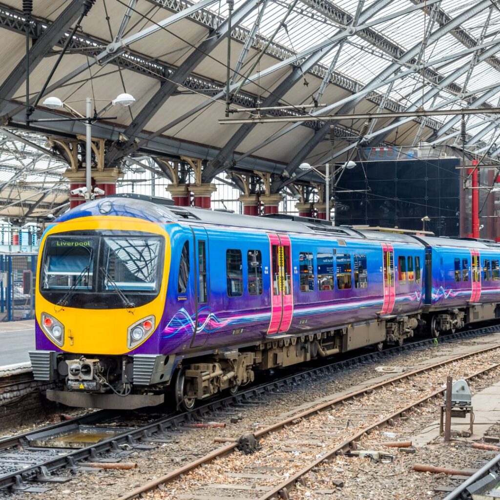 A photo of a train pulling in to an indoor station