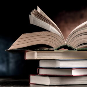 An open glossary on a stack of books