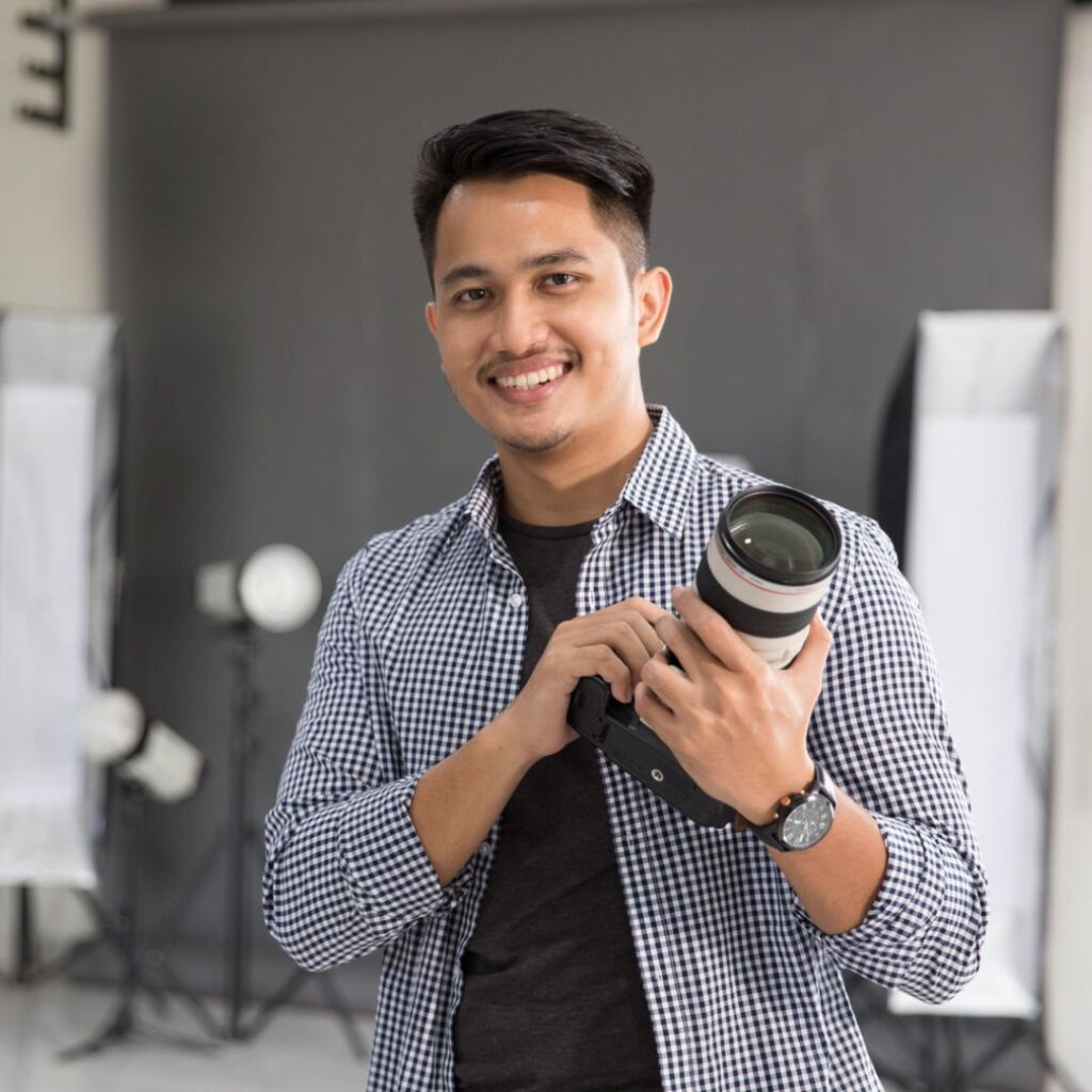 A professional photographer holding a camera